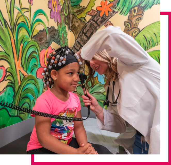 Doctor in white lab coat doing an ear exam on patient